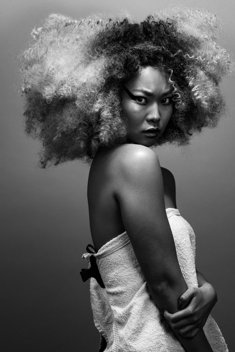 Editorial photography by Ibiza-based photographer Rob Woo – studio portrait of asian model with dramatic shadows and strong eye contact